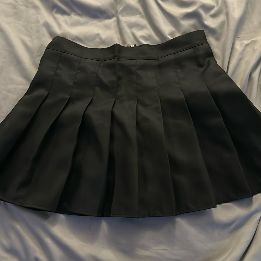 Mini pleated flare skirt in black.